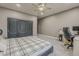 A bedroom featuring a desk area for work and a sleek closet for plenty of storage space at 1441 E Folley Pl, Chandler, AZ 85225