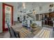 Dining room with table set for dinner with a red door, and open access to the living room and kitchen at 1441 E Folley Pl, Chandler, AZ 85225