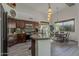 Well-lit kitchen with an island, wood cabinets, granite countertops and adjacent dining area at 1441 E Folley Pl, Chandler, AZ 85225