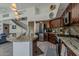 Spacious kitchen with stainless steel appliances, and granite countertops adjoined to a staircase at 1441 E Folley Pl, Chandler, AZ 85225