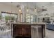 Kitchen island with granite countertops, stainless steel dishwasher, and view of dining area and backyard at 1441 E Folley Pl, Chandler, AZ 85225