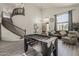 Open-concept living room featuring a foosball table and staircase to the upper level at 1441 E Folley Pl, Chandler, AZ 85225
