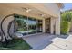 Covered outdoor patio featuring a comfortable hanging chair and glass sliding door entry at 1441 E Folley Pl, Chandler, AZ 85225