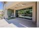 Covered outdoor patio with ceiling fans, decorative hanging chair, and glass sliding doors at 1441 E Folley Pl, Chandler, AZ 85225