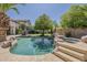 Inviting backyard pool with a rock waterfall, spa, and lush landscaping for ultimate relaxation at 1441 E Folley Pl, Chandler, AZ 85225