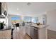 Open-concept kitchen and living room with a granite island and stainless steel appliances at 1443 W Tigua Way, Coolidge, AZ 85128