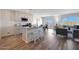 Bright, open-concept living room and kitchen with a granite island and modern appliances at 1443 W Tigua Way, Coolidge, AZ 85128