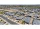Expansive aerial view of a vibrant neighborhood with uniformly designed homes and well-maintained landscaping at 1560 E Squire Dr, Casa Grande, AZ 85122