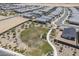 Aerial view showcases community green space in neighborhood with walking paths and desert landscaping at 1560 E Squire Dr, Casa Grande, AZ 85122