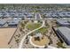Aerial view of community green space with park, playground, walking path in neighborhood with desert landscaping at 1560 E Squire Dr, Casa Grande, AZ 85122