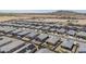 Neighborhood aerial showing uniform home design, desert landscaping, mountain views in the distance at 1560 E Squire Dr, Casa Grande, AZ 85122