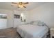 Bedroom features a ceiling fan, neutral decor, ensuite bathroom access, and a calm and peaceful setting at 1560 E Squire Dr, Casa Grande, AZ 85122