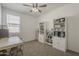 Bedroom featuring shelving units, a ceiling fan and a window for natural light at 1560 E Squire Dr, Casa Grande, AZ 85122