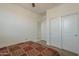 Simple bedroom with a patterned bedspread, a ceiling fan, and a closet with sliding doors at 1560 E Squire Dr, Casa Grande, AZ 85122