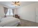 Bright bedroom features a ceiling fan, natural light, and comfortable chair creating a serene retreat at 1560 E Squire Dr, Casa Grande, AZ 85122