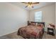Cozy bedroom featuring a patterned bedspread, ceiling fan, and a window letting in natural light at 1560 E Squire Dr, Casa Grande, AZ 85122