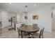 Eat-in kitchen dining area features a round table and a view of the stainless steel appliances and granite countertops at 1560 E Squire Dr, Casa Grande, AZ 85122