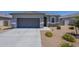 Charming single-story home featuring a two-car garage and low-maintenance desert landscaping at 1560 E Squire Dr, Casa Grande, AZ 85122
