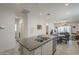 Open concept kitchen featuring a large island with granite countertops, tile flooring, and access to the living spaces at 1560 E Squire Dr, Casa Grande, AZ 85122