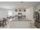 Modern kitchen with an island, stainless steel appliances, and bright lighting at 1560 E Squire Dr, Casa Grande, AZ 85122