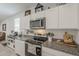 Kitchen with sleek countertops, stainless steel appliances, and white cabinets with great storage at 1560 E Squire Dr, Casa Grande, AZ 85122