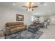 Open-concept living room and kitchen with ceiling fan, seamless flow for modern living and entertaining at 1560 E Squire Dr, Casa Grande, AZ 85122