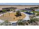 Aerial view of a playground featuring a swing set, slide, and picnic tables with shade covering at 1560 E Squire Dr, Casa Grande, AZ 85122