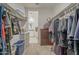 Well-organized walk-in closet featuring shelves, drawers, hanging rods, and access to the ensuite bathroom at 1560 E Squire Dr, Casa Grande, AZ 85122