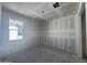 Spacious bedroom featuring a large window and unfinished walls and flooring at 16178 W Bajada Rd, Surprise, AZ 85387