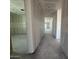 View down a long hallway with rooms and an abundance of natural light at 16178 W Bajada Rd, Surprise, AZ 85387