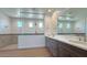 Modern bathroom boasts dual vanities, wood-look floors, and a frameless glass shower at 16777 W Sheila Ln, Goodyear, AZ 85395