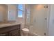 Bright bathroom featuring a tiled shower with glass enclosure and a stylish vanity with solid surface counters at 16777 W Sheila Ln, Goodyear, AZ 85395