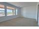 Spacious carpeted bedroom with big windows offering abundant natural light and outdoor views at 16777 W Sheila Ln, Goodyear, AZ 85395
