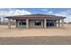 Rear exterior of home featuring a covered patio and desert landscaping with a tile roof at 16777 W Sheila Ln, Goodyear, AZ 85395