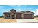 Charming home showcases a stone facade accent, dual-car garage, and desert landscaping at 16777 W Sheila Ln, Goodyear, AZ 85395