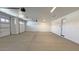 Spacious three car garage with smooth concrete floors and white walls, providing ample parking and storage at 16777 W Sheila Ln, Goodyear, AZ 85395