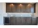 Stylish living area with custom cabinetry, a mini-fridge, and modern finishes for entertaining at 16777 W Sheila Ln, Goodyear, AZ 85395
