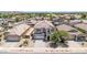Aerial view of neighborhood with two-story home, desert landscaping, and three-car garage at 16917 W Sonora St, Goodyear, AZ 85338