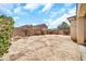 Neutral backyard showcasing block wall, bushes, and open area at 16917 W Sonora St, Goodyear, AZ 85338