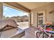 Covered patio area in the backyard with BBQ, door, and access to the rest of the yard at 16917 W Sonora St, Goodyear, AZ 85338