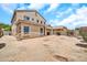 Wide angle backyard view of home, covered patio, block wall, and flower bushes at 16917 W Sonora St, Goodyear, AZ 85338