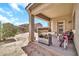 Covered patio area in the backyard with BBQ, door, and access to the rest of the yard at 16917 W Sonora St, Goodyear, AZ 85338