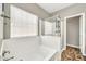 Bright bathroom featuring a bathtub with glass door shower and modern fixtures at 16917 W Sonora St, Goodyear, AZ 85338