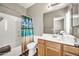 Clean bathroom showcasing a shower/tub combo with a sink and tropical shower curtain at 16917 W Sonora St, Goodyear, AZ 85338