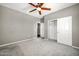 Empty bedroom with carpet and large closet and a ceiling fan at 16917 W Sonora St, Goodyear, AZ 85338