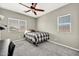 Cozy carpeted bedroom with ceiling fan, multiple windows and neutral walls at 16917 W Sonora St, Goodyear, AZ 85338