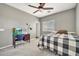 Bedroom featuring carpet, a ceiling fan, and a desk area at 16917 W Sonora St, Goodyear, AZ 85338