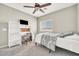 Bedroom with carpet, ceiling fan, desk, and nice built-in shelving and cabinets at 16917 W Sonora St, Goodyear, AZ 85338