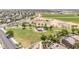 Aerial view of a community park featuring a playground, green space, and walking paths at 16917 W Sonora St, Goodyear, AZ 85338