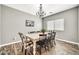 This dining room features modern decor with a wooden table and black-and-white accents at 16917 W Sonora St, Goodyear, AZ 85338